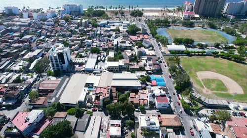 downtown Puerto Vallarta on a sunny day with blue ocean coastline in Mexico, aerial