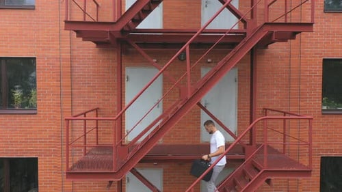 Businessman Going Down the Stairs of a Business Centre Building