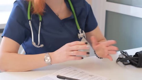 A Female Doctor is Talking to a Patient Close Up