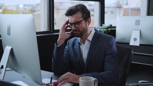 A Business Professional Engaged in Work at a Contemporary Office Desk in a Dynamic Environment