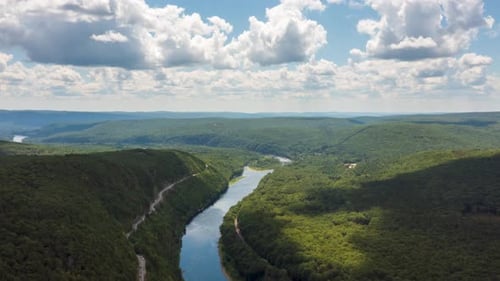 Aerial View of River Winding Through Forested Valley