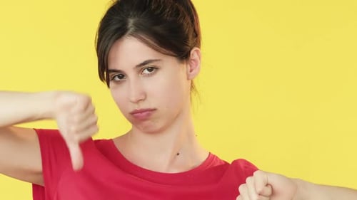 Young Woman Giving Thumbs Down Gesture