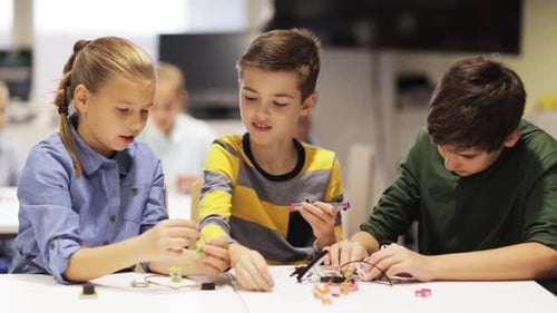 Children Collaborate on Electronics Project in Classroom Setting