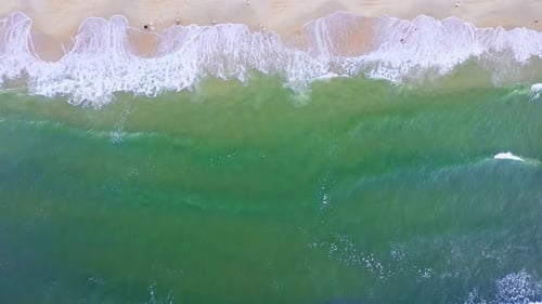 Aerial Top view of a transparent blue sea with beautiful waves at sunny day in summer. air of ocean