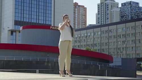 Woman Talking on Cell Phone in Urban Environment