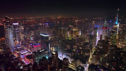 Immense New York panorama at night time. Tremendous city scenery in lights with dark river