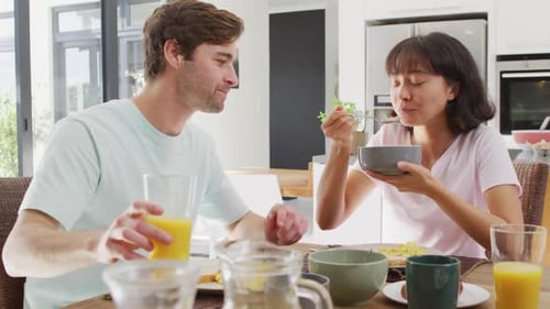 Young Couple Enjoying Breakfast Together at Home
