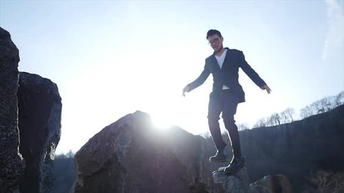 Male Person Walking Over Stone Rocks Overcoming Obstacles and Succeed