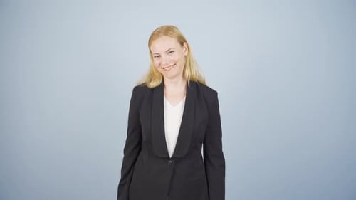 Business woman happily speaking to camera.