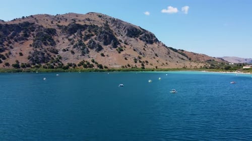 Aerial Orbit View over Kournas Lake with Turquoise Waters and Pleasure Boats, Crete, Greece