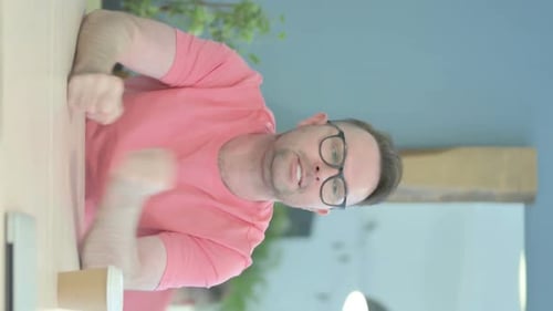Adult Man Talking and Resting at Table Indoors