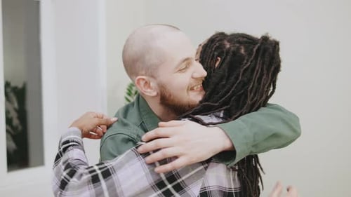 Affectionate Couple Kisses and Embraces Indoors
