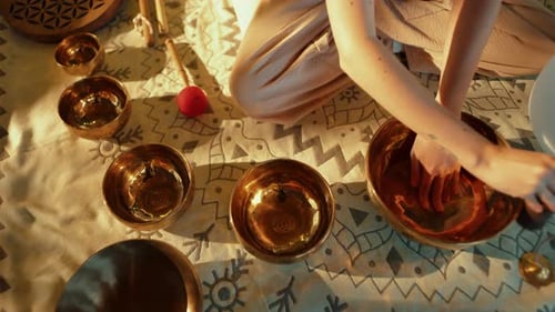 Woman Makes Sound on Tibetan Singing Bowls