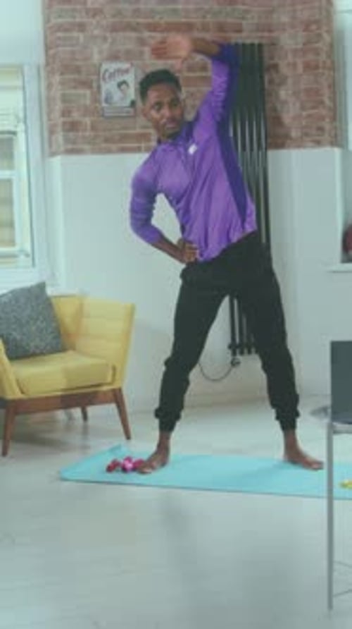 Man Stretching with Weights Nearby Vibrant Home Fitness Session Showing Stretching and Mobility