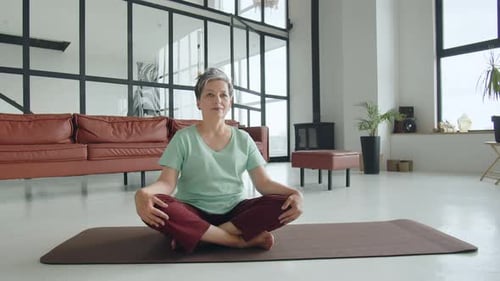 Old Woman Make Yoga Exercise at Home Mature Woman Have Meditation He Rise Hands Up and Close Her