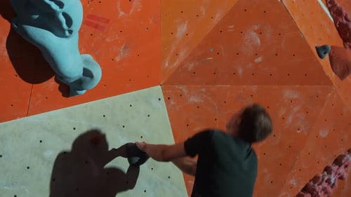 Young Man Climbing Indoor Rock Climbing Wall