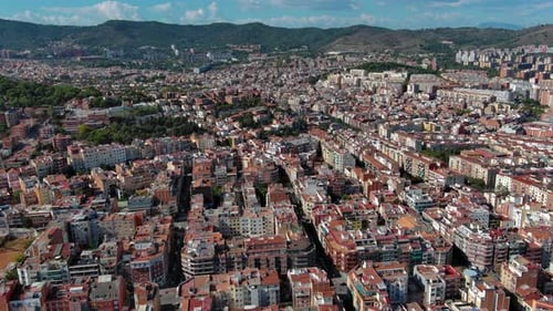 Barcelona city skyline, aerial view of Horta Guinardo and Nou Barris districts during a sunny day