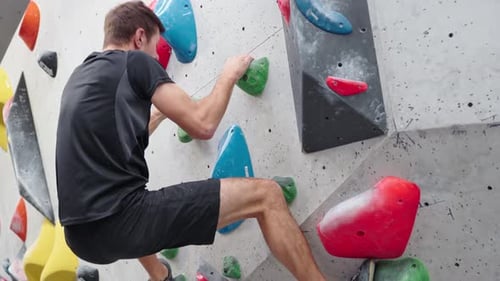 Man Training at Bouldering Gym