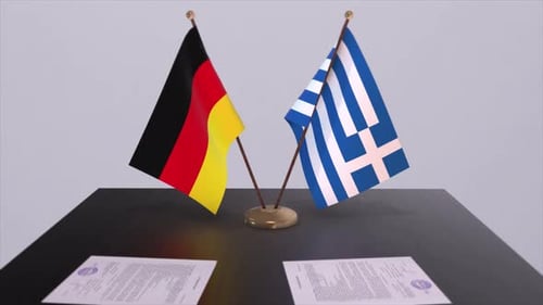 German and Greek Flags on a Table