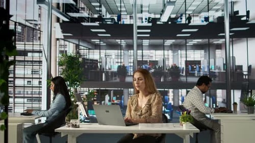 Female Executive Reviewing Business Operations at Her Desk