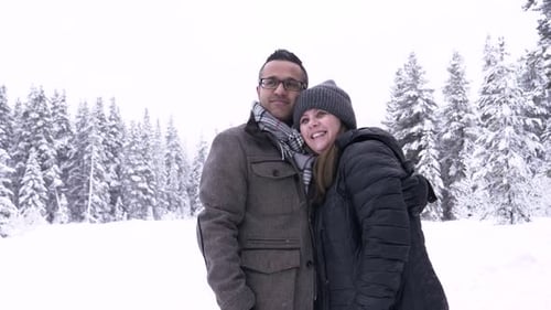 Happy Couple in Snowy Winter Woods Active