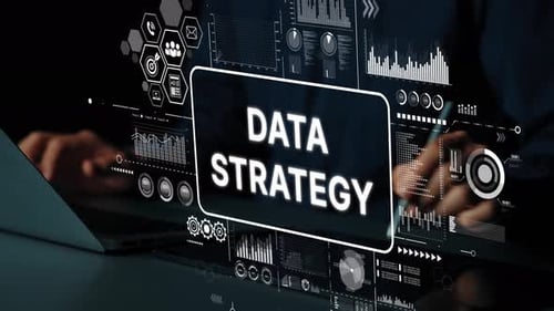 Tippen mit den Händen auf dem Laptop mit Overlay-Grafiken für Datenstrategie und Analytik in einer modernen Arbeitsumgebung