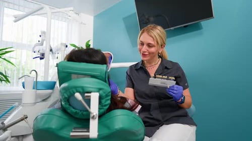 Dentist Matching Shade Guide to Patient's Teeth