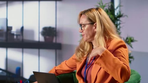 Woman Working at Laptop in Modern Office