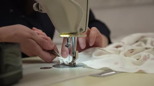 Seamstress Working With Sewing Machine on Fabric