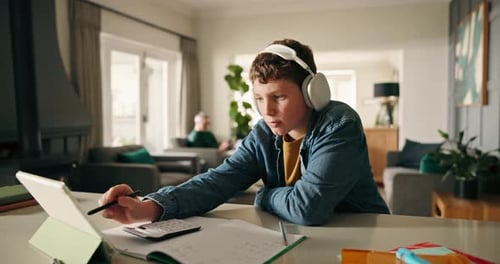 Boy, homework and tablet with e learning, book and headphones with study