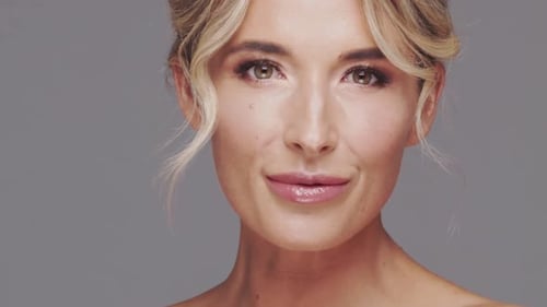 Studio Portrait of Young and Beautiful Blond Woman Over Grey Background Skin Care and Wellness