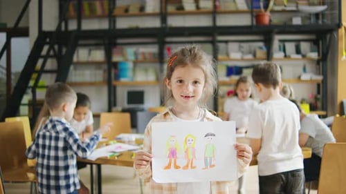 Children Drawing in a Classroom at School