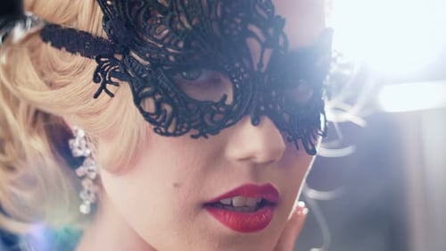 Elegant Woman with Lace Mask and Red Lipstick