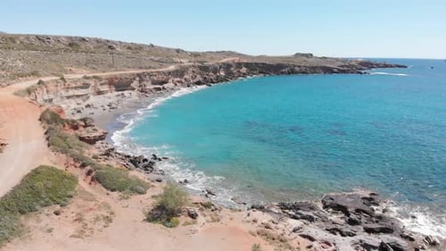 Aerial beautiful beach and water bay in the greek spectacular coast line. Turquoise blue transparent