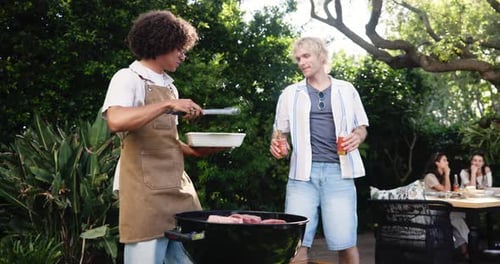 Friends Enjoying Outdoor Barbecue in Green Backyard