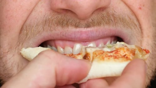 Young Man Takes Bite From Pizza with Pleasure Slow Motion
