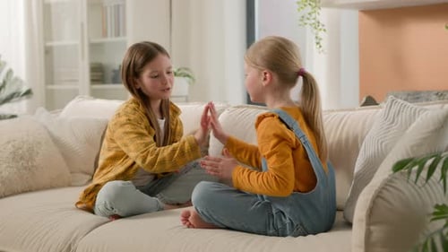 Two Little Smiling Happy Playful Caucasian Kids Girls Sisters Friends Children Clapping Their Hands