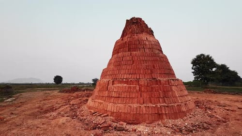 Brick Pyramid in Rural Environment on Cloudy Day