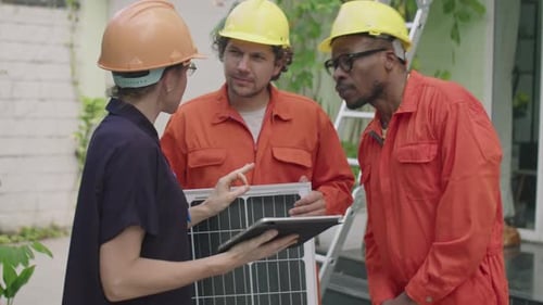 Female Engineer Instructing Multiethnic PV Installers