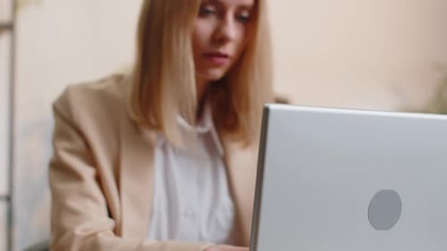 Business Woman Freelancer at Office Workplace Desk Working on Laptop Computer Sends Online Messages