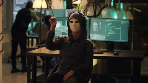 Woman with Mask Gesturing in Dark Office