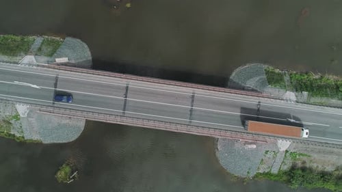 Aerial Top Down View of Small Road Bridge Across the River in Rural Area Many Cars Driving on the
