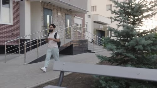 Man Walking With Phone