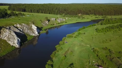 A Stunning Aerial View Capturing a Serene River That is Beautifully Surrounded By Lush Greenery