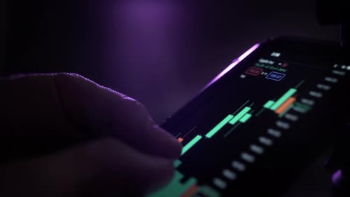 A Man Holds a Smartphone in His Hands Buys Stocks Deals with Crypto and Trading