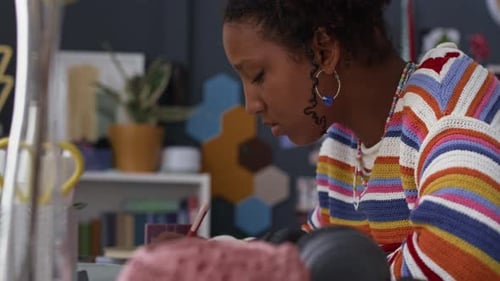 Concentrated Black Teenage Girl Writing School Assignment Studying at Home