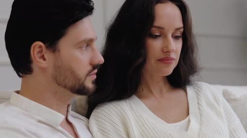 Couple Talking Together at Home on Couch