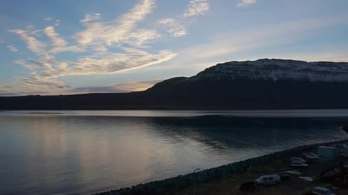 Iceland arctic sea landscape with snow capped mountains in background, sunset, static
