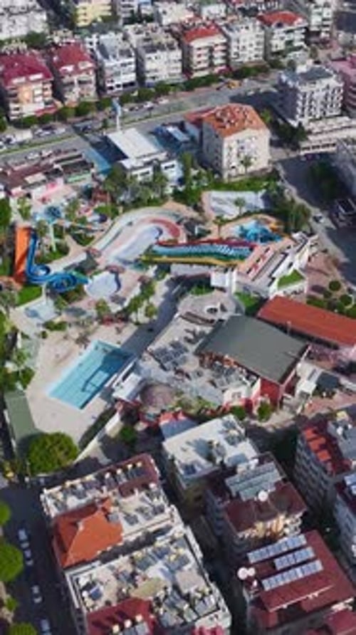 Vertical Video of a Closed Water Park Featuring Colorful Slides Lazy Rivers and a Large Wave Pool