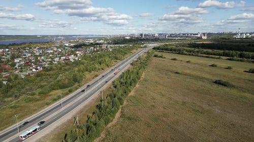A Stunning Aerial View of an Urban Landscape Featuring a Highway and Expansive Fields Clip